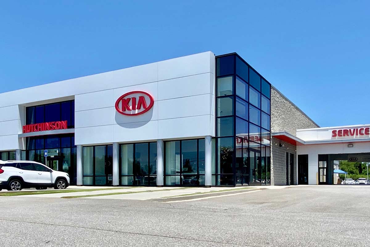 The Hutchinson Kia dealership in Albany, Georgia is a weathertight metal building with large windows and red accents. The Hutchinson Kia dealership in Albany, Georgia is a weathertight metal building with large windows and red accents.