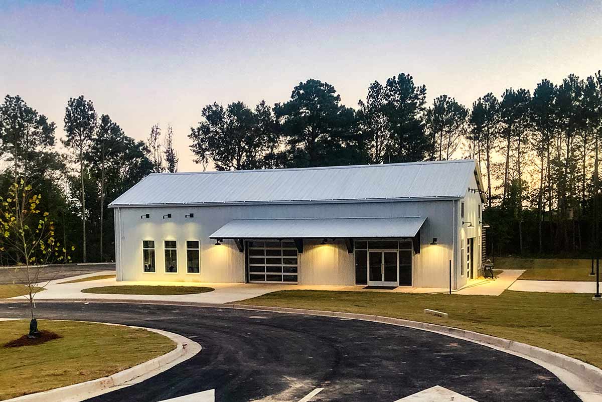 Young Life is a modern but simply designed metal building with galvalume roof and walls panels and rollup doors for air flow.