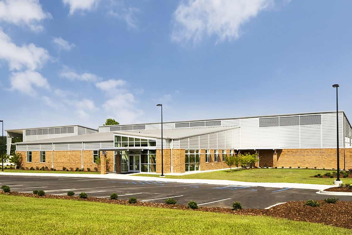 A metal building at Orangeburg-Calhoun Technical College has metal wall panels mixed with masonry and a standing seam roof.