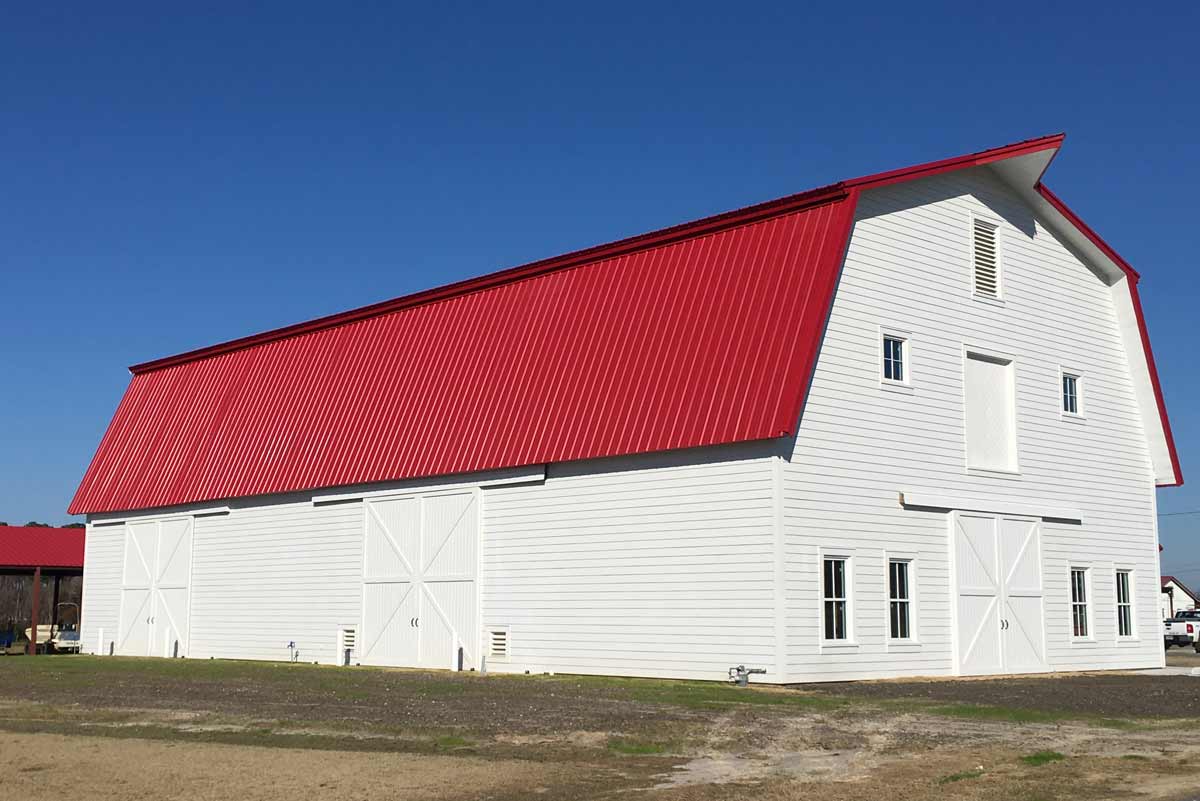 This 5100 square foot gabrel style metal barn is 42 feet high at its peak and topped with 24-gauge PBR Kynar roof coated in bright red. This 5100 square foot gabrel style metal barn is 42 feet high at its peak and topped with 24-gauge PBR Kynar roof coated in bright red.